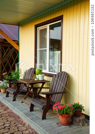 terrace with place to relax in fresh air in front of One-story motel houses. terrace with place to relax in fresh air in front of One-story motel houses. 106985182