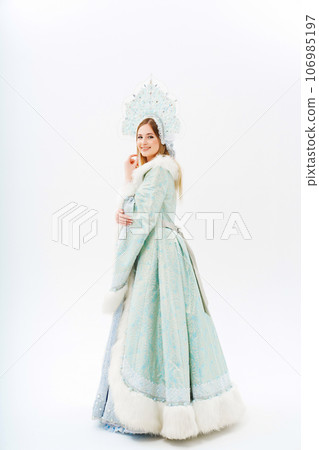 Snow Maiden in a traditional costume with a kokoshnik on a white background. Snow Maiden in a traditional costume with a kokoshnik on a white background. 106985197