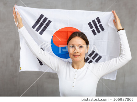 Happy woman posing with national flag of South Korea Happy woman posing with national flag of South Korea 106987805