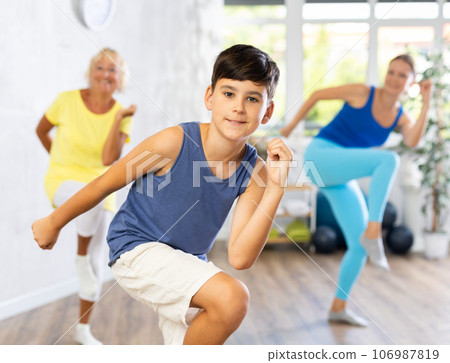 Happy preteen boy practicing dance positions during workout session Happy preteen boy practicing dance positions during workout session 106987819