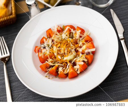 Salad made of tomato and deviled egg served on table 106987883