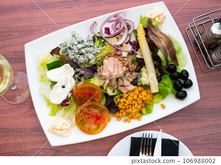 Appetizing salad with tuna, cheese, corn and olives 106988002