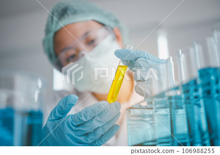 Female researchers are experimenting with pipette dropping a sample into a test tube in an experiment research in laboratory... Female researchers are experimenting with pipette dropping a sample into a test tube in an experiment research in laboratory... 106988255