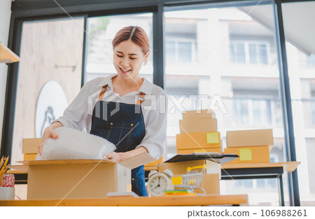 Online small business owners are packing their ordered products into the boxes for their customers based on the concept of online shopping - online shopping. Online small business owners are packing their ordered products into the boxes for their customers based on the concept of online shopping - online shopping. 106988261