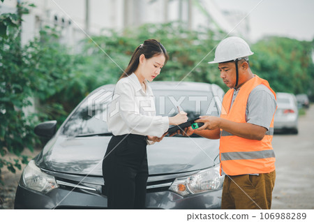 male insurance officer came to help inspect a customer's car that had an accident. Concept for vehicle crash, insurance claim. 106988289