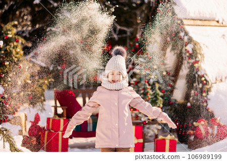 Girl on decorated Christmas street in winter Girl on decorated Christmas street in winter 106989199