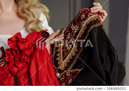 Hands of a medieval seamstress in a vintage dress Hands of a medieval seamstress in a vintage dress 106989201