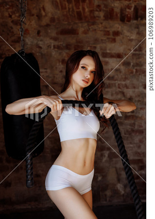 Woman holding sports rope in the gym Woman holding sports rope in the gym 106989203