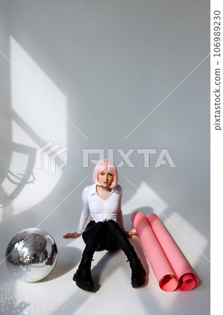 Contemporary Pink-Haired Woman in Minimalist Studio 106989230