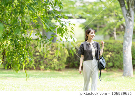 A woman walking in the park 106989655