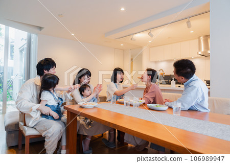 A large family eating together A large family eating together 106989947