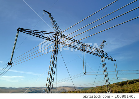 Steel pillar with high voltage electric power lines delivering electrical energy through cable wires on long distance 106991405