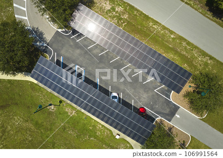 Solar panels installed over parking lot for parked cars for effective generation of clean energy Solar panels installed over parking lot for parked cars for effective generation of clean energy 106991564