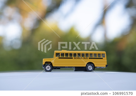 Small model of american yellow school bus as symbol of education in the USA 106991570