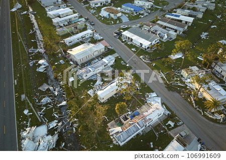 Severely damaged houses after hurricane Ian in Florida mobile home residential area. Consequences of natural disaster Severely damaged houses after hurricane Ian in Florida mobile home residential area. Consequences of natural disaster 106991609