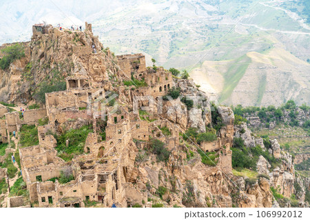 Dagestan Gamsutl. Ancient ghost town of Gamsutl old stone houses in abandoned Gamsutl mountain village in Dagestan, Abandoned etnic aul, summer landscape. 106992012