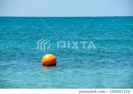 Orange buoy floating on sea surface waves. Human life safety concept. 106992168