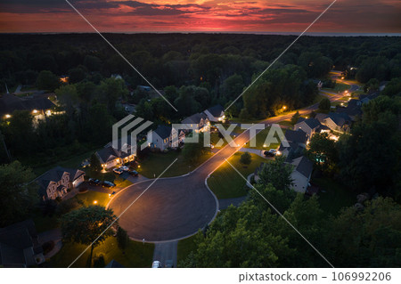 Low-density two story private homes at sunset. Rural street cul-de-sac dead end in residential suburbs with upscale suburban houses outside of Rochester, New York 106992206