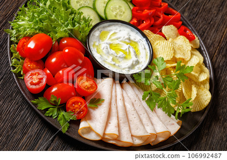 ham, chips, leafy greens, veggies snack platter 106992487