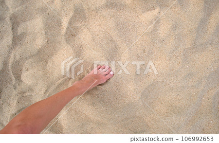 Female bare feet standing on beach sand Female bare feet standing on beach sand 106992653