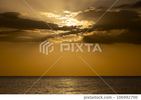 Dramatic red ocean waves at sunset with soft evening sea dark water Dramatic red ocean waves at sunset with soft evening sea dark water 106992700