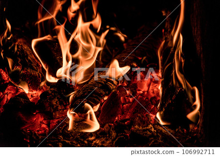 Close up picture of wood burning in a camp fire. Hot Red Flames. Taken in Nova Scotia, Canada Dark Mood Close up picture of wood burning in a camp fire. Hot Red Flames. Taken in Nova Scotia, Canada Dark Mood 106992711