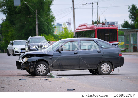 Damaged in car accident vehicle on city street crash site 106992797