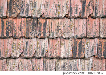 Closeup surface of old weathered ceramic tiles covering building roof 106992837