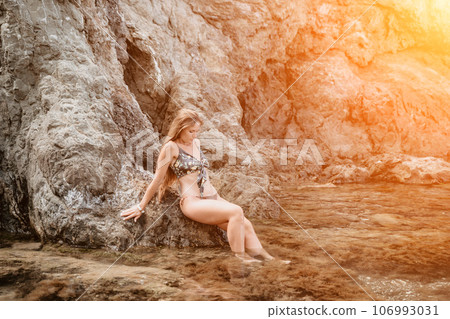Woman travel sea. Happy tourist enjoy taking picture outdoors for memories. Woman traveler swim in the sea bay with mountains, sharing travel adventure journey Woman travel sea. Happy tourist enjoy taking picture outdoors for memories. Woman traveler swim in the sea bay with mountains, sharing travel adventure journey 106993031