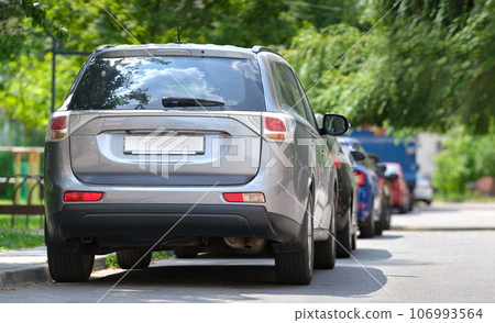 City traffic with cars parked in line on street side. Vehicle parking concept. 106993564