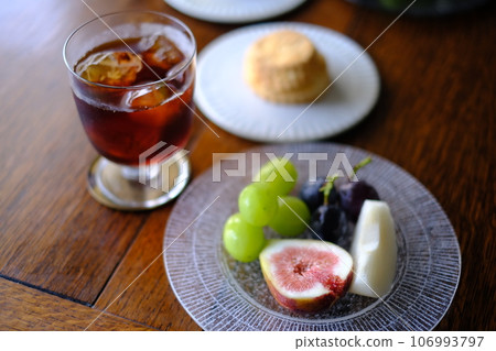 Dining table lined with fruit and scones Dining table lined with fruit and scones 106993797