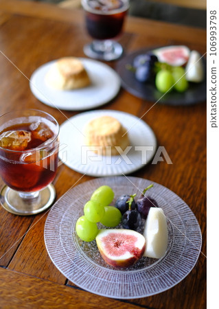 Dining table lined with fruit and scones Dining table lined with fruit and scones 106993798