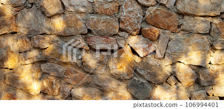 Sturdy yellow and beige cut stone wall made in Datca, Turkey, seamless lined up 106994401