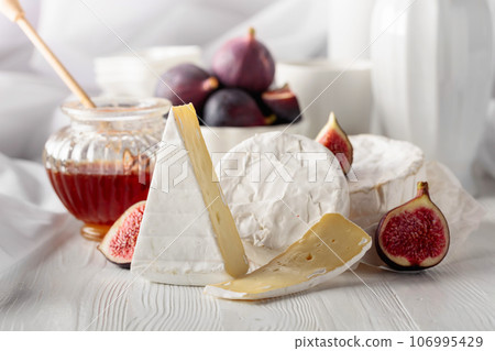 Camembert cheese with figs and honey. 106995429