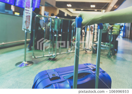 Abstract blurred people with luggage waiting in airport 106996933