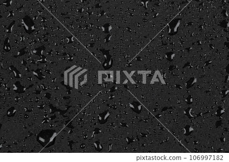 Water drops on dark stone Water drops on dark stone 106997182