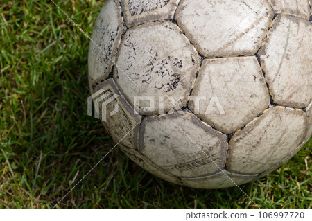 Soccer ball on green grass of football field with copy space Soccer ball on green grass of football field with copy space 106997720