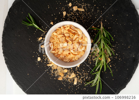 Dry Garlic Slices, Crispy Fried Cloves Pile Closeup, Roasted Grilled Garlic Flakes, Clove Chip Group Dry Garlic Slices, Crispy Fried Cloves Pile Closeup, Roasted Grilled Garlic Flakes, Clove Chip Group 106998216