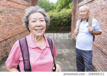 Happy senior couple tourists outdoors in historic town Happy senior couple tourists outdoors in historic town 106999151