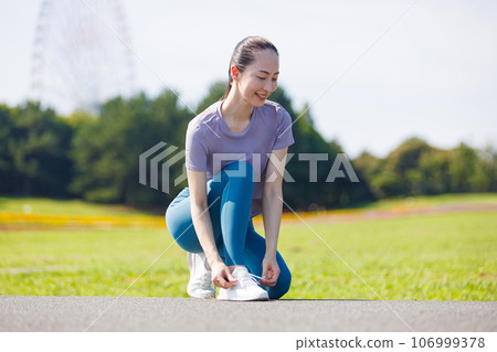 A woman stretching in the park A woman stretching in the park 106999378