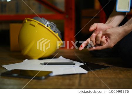 Injured male worker with bleeding blood from the cut finger wound. Safety first, Industrial accident and insurance concept 106999576