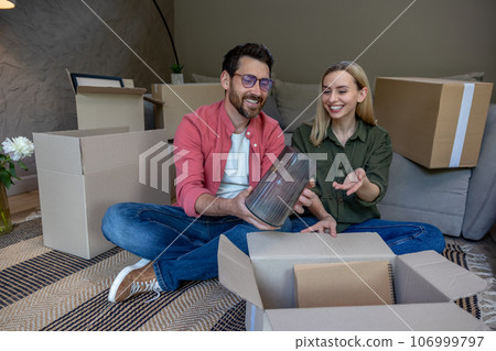 Wife and husband preparing for the move to a new house Wife and husband preparing for the move to a new house 106999797