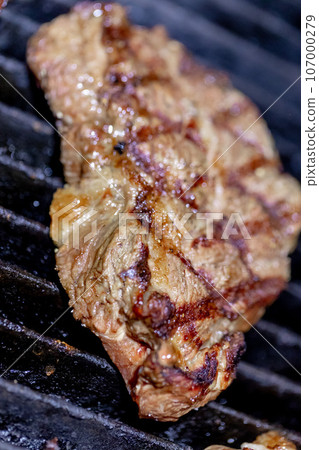 Beef steak grilled on lava stone charcoal griddle 107000279