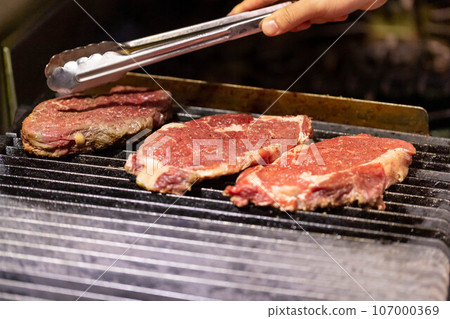 Beef steak grilled on lava stone charcoal griddle Beef steak grilled on lava stone charcoal griddle 107000369
