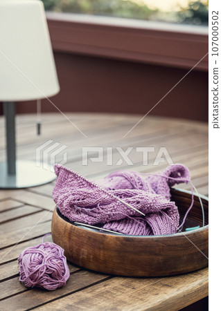Knitting project of knitting women's pink sweater in progress. Knitting project of knitting women's pink sweater in progress. 107000502