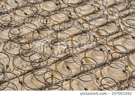 close-up of an old spring mattress. structure of the spring mattress. close-up of an old spring mattress. structure of the spring mattress. 107001892