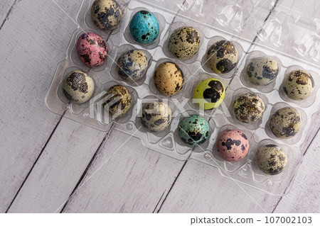 colorful Easter eggs in a container on a light background colorful Easter eggs in a container on a light background 107002103