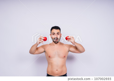 Man, hands and holding apple on white background in studio for health, wellness or immune support. Man, hands and holding apple on white background in studio for health, wellness or immune support. 107002693