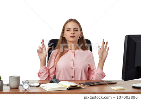 businesswoman showing fingers crossed for good luck in office 107002896