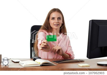 beautiful young businesswoman holding plastic credit card 107002903
